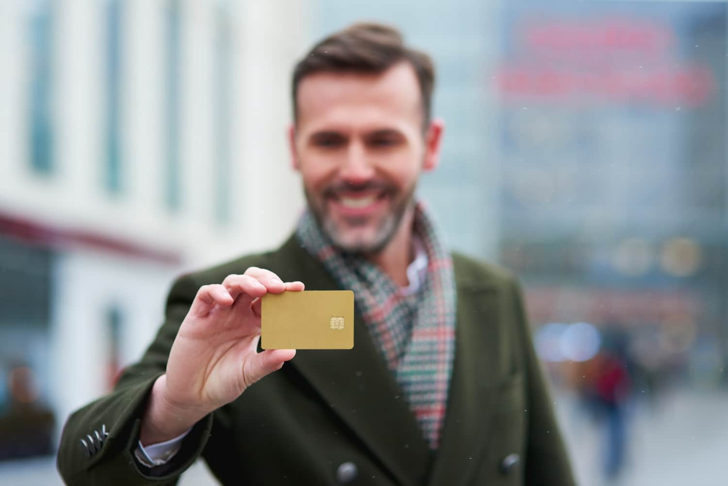 A man holding his American Express Gold Rewards.