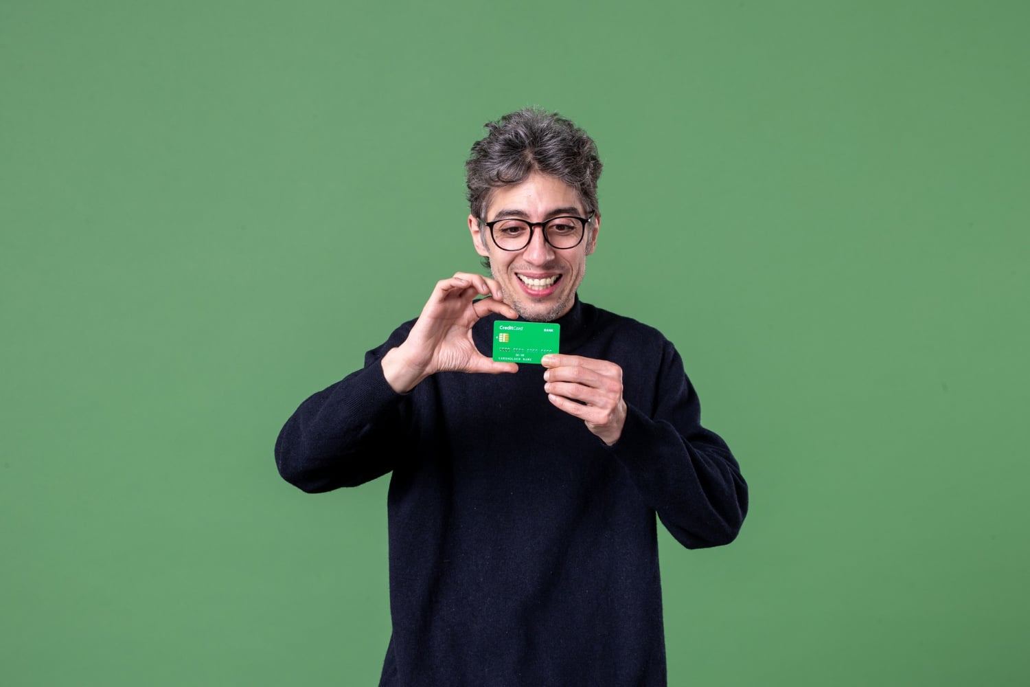 A guy holding the American Express Green Card.