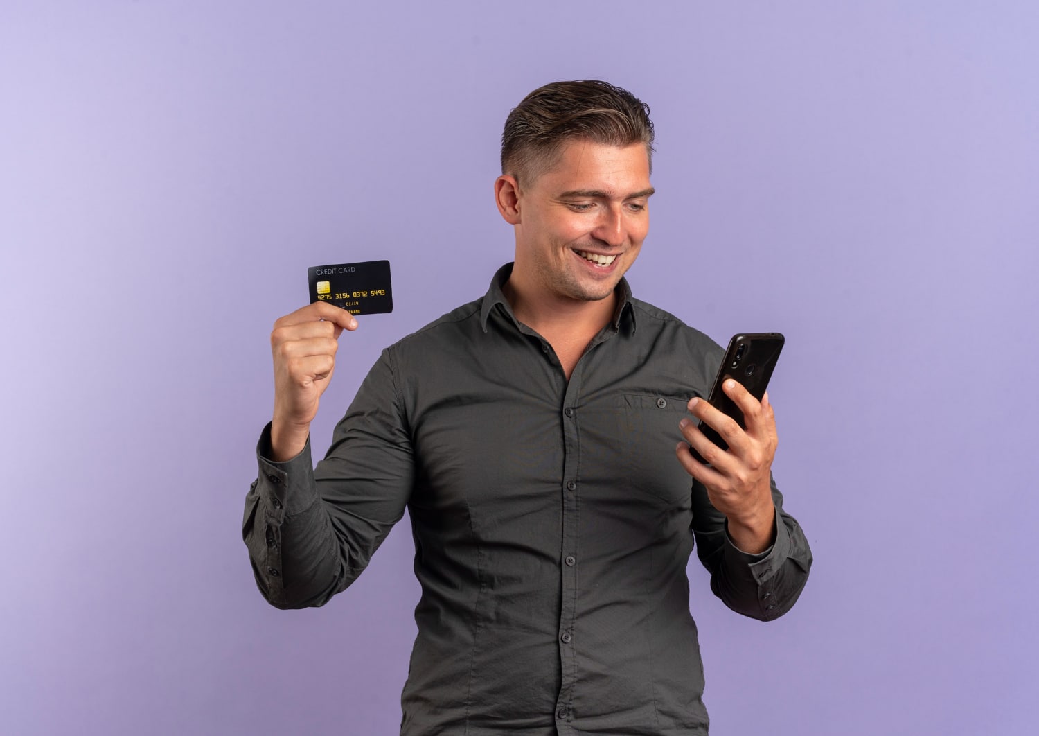 A guy holding his Scotiabank Passport Visa Infinite.