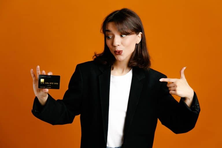 A girl holding her Scotiabank Passport Visa Infinite Card.