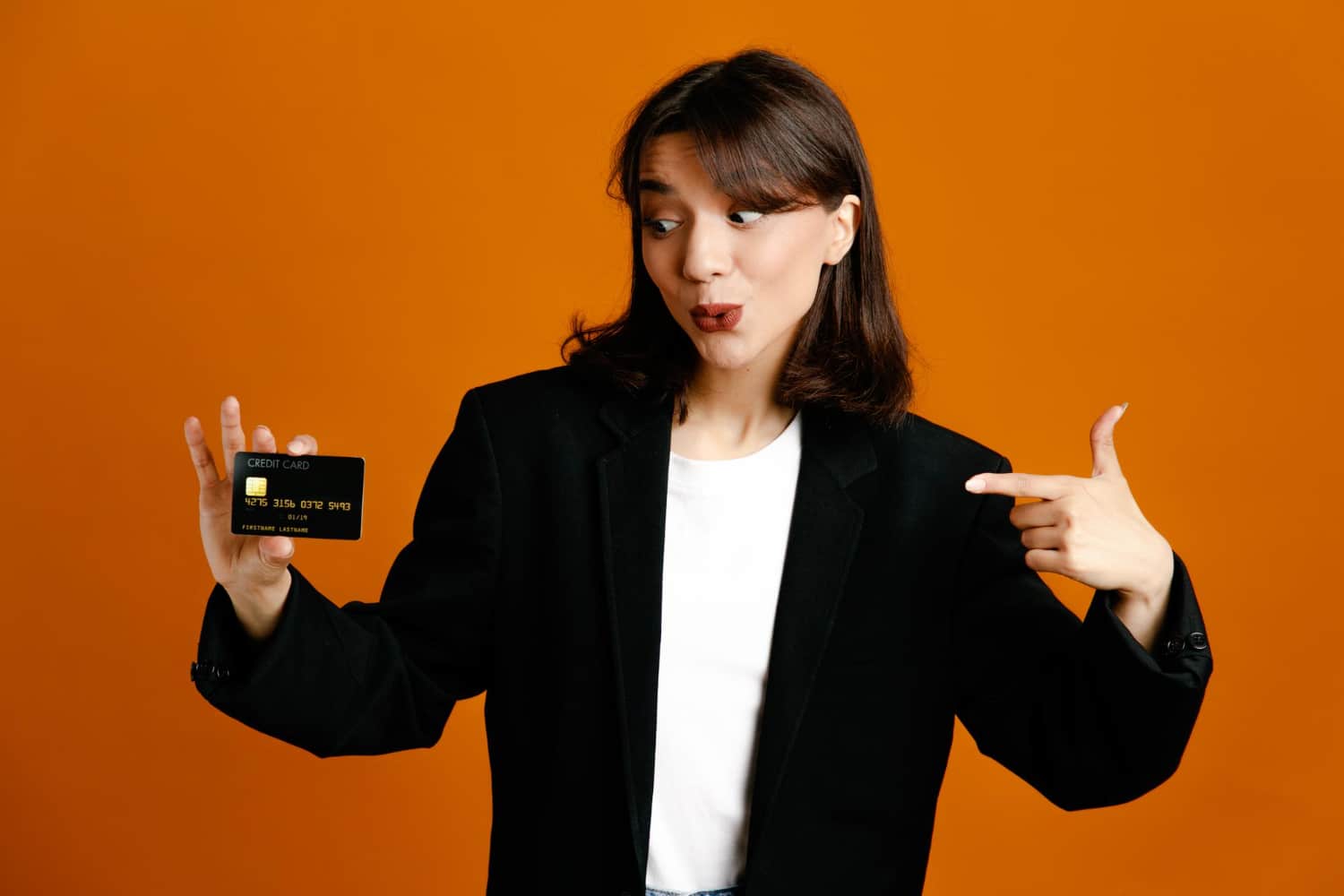 A girl holding her Scotiabank Passport Visa Infinite Card.