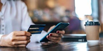 A woman using the VentureOne Rewards at a restaurant.