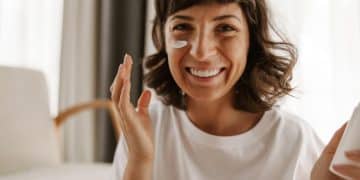 Woman using facial sunscreen.