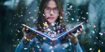 A girl reading Romantasy Books.