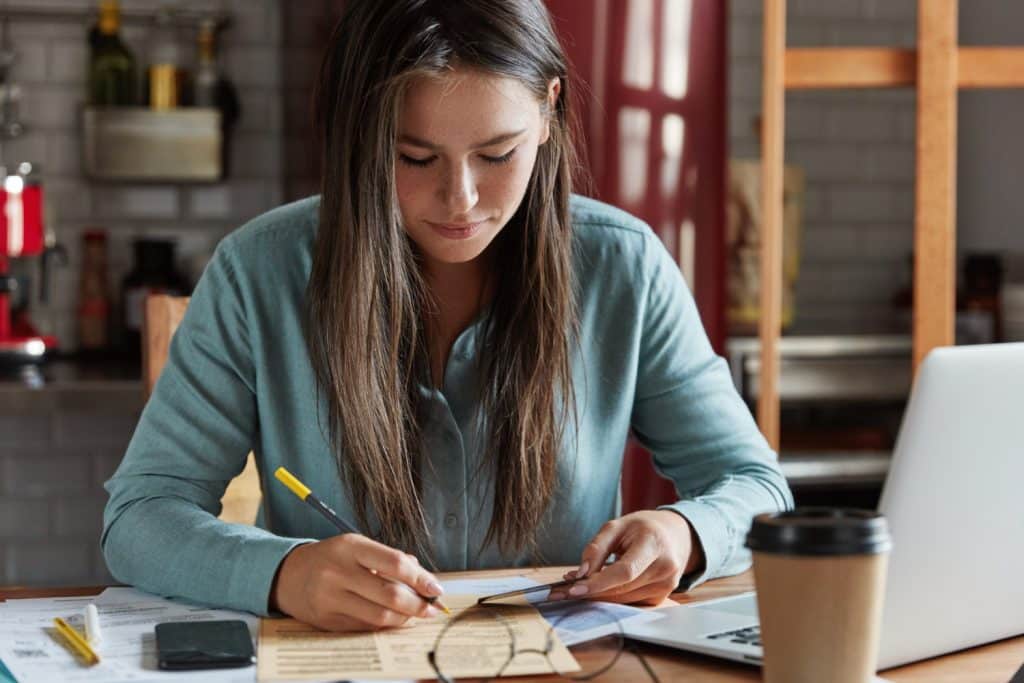 student reads and calculates education expenses on student credit card