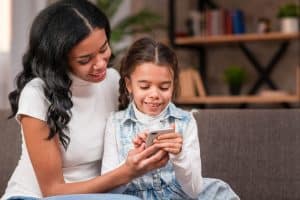 mother with her daughter using parental control app