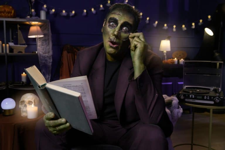 A man dressed as Frankstein enjoying Scary Books for October.