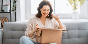 woman is unpacking cardboard